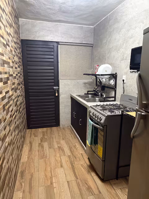 Equipped kitchen with gas stove and refrigerator