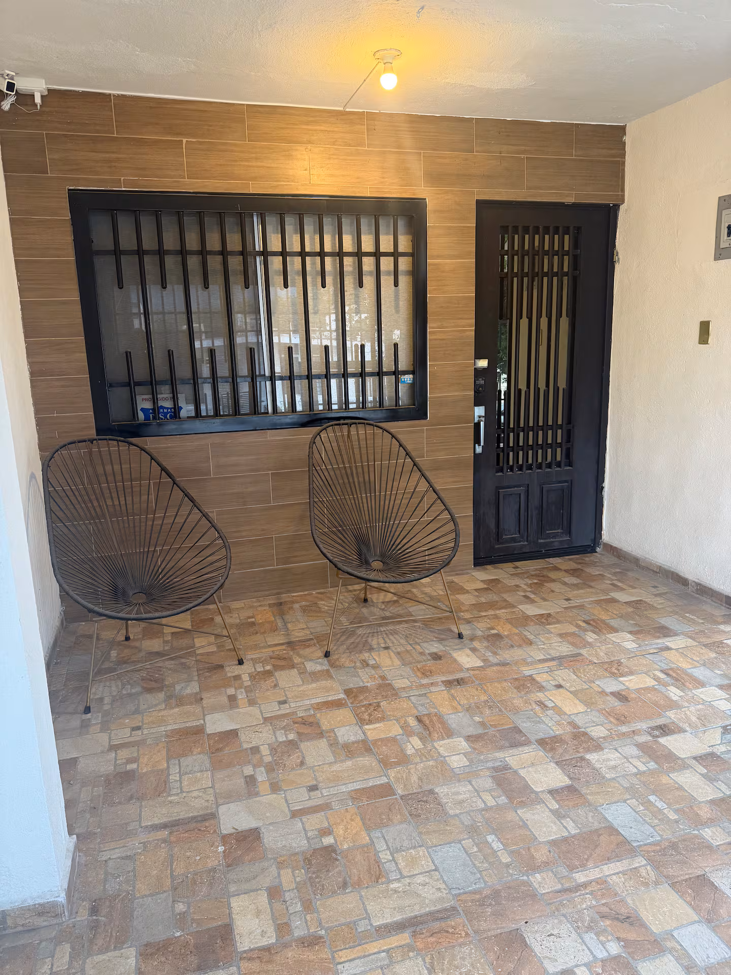 Covered patio with seating and entrance to the house