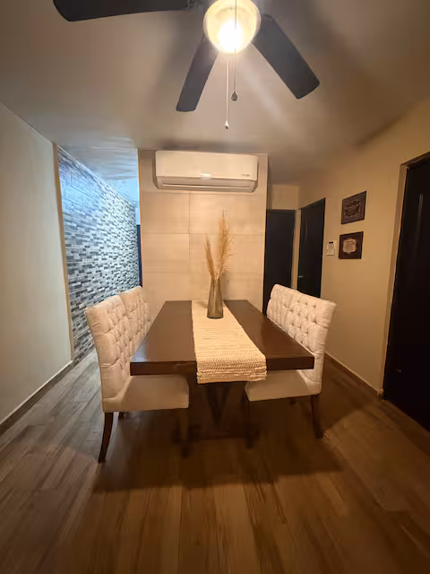 Dining area with table, chairs and air conditioning