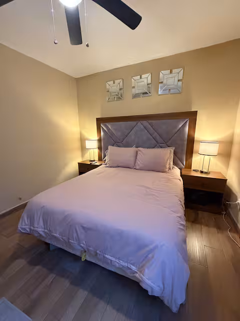 Bedroom with a queen bed and warm decor